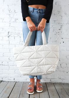 You'll love this Large Quilted Nylon Tote! It's made from durable, lightweight nylon and features a quilted pattern for added style. The spacious interior is perfect for carrying all your daily essentials, while the comfortable shoulder straps make it easy to carry. Plus, the neutral chalk color goes with everything! This tote is both stylish and functional - you won't want to leave home without it! Casual Nylon Puffer Bag, Everyday Quilted Nylon Bag, Trendy Quilted Nylon Bag, Casual Quilted Nylon Bag, Spring Quilted Nylon Bags, Casual Insulated Nylon Bags, Quilted Pattern, Nylon Tote, Daily Essentials