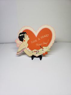 a heart shaped card with an image of a woman holding a man's hand