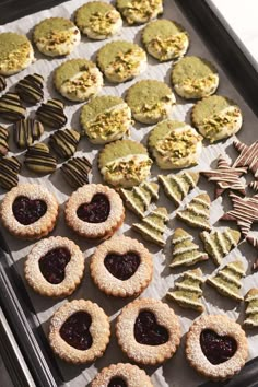 cookies and pastries are arranged on a baking sheet