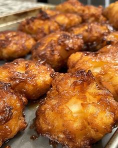 some fried food is sitting on a metal tray and ready to be cooked in the oven