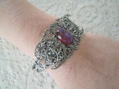 This beautiful silver plated filigree cuff bracelet has a silver plated triple moon design and a glass dragon's breath fire opal setting. Adjustable. Adjustable Silver Fantasy Bracelet, Handmade Adjustable Gothic Bracelet, Handmade Adjustable Gothic Bracelets, Silver Fantasy Bracelet, Handmade Gothic Metal Bracelets, Dragons Breath Fire Opal, Goddess Witch, Victorian Cosplay, Wicca Jewelry