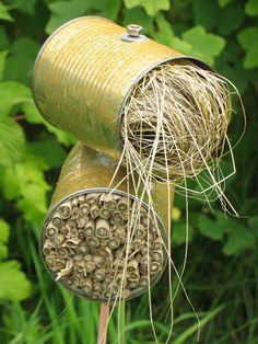 a close up of a metal object with grass growing out of it's top