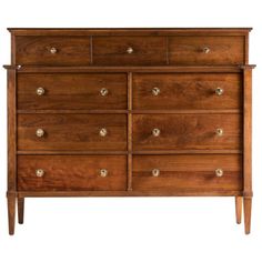 a wooden dresser with many drawers and knobs