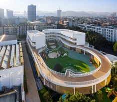 an aerial view of a building with a green lawn