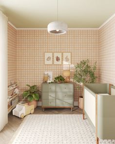 a baby's room with a crib, dresser and potted plant in the corner