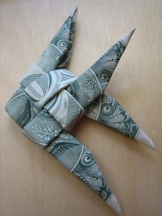 an origami bird made out of dollar bills