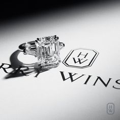 a diamond ring sitting on top of a piece of paper with the word winning written below it