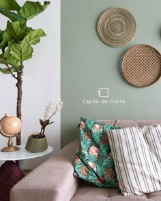 a living room filled with furniture next to a wall covered in plants and pictures on the walls