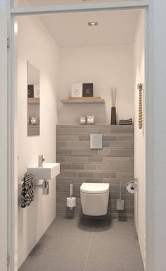 a white toilet sitting inside of a bathroom next to a sink