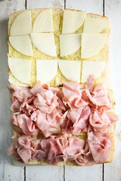 slices of bread with ham and cheese on them