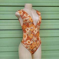 Tags Still Attached, Liner Not Attached, And Never Worn. Zara One Piece Deep-V Swimsuit! Beautiful Warm Orange Colors And Florals. 80% Polyester Brown Fitted V-neck Swimwear, Fitted Brown V-neck Swimwear, Fitted Orange V-neck Bodysuit, Brown V-neck Swimwear For The Beach, Summer V-neck Printed Bodysuit, Brown One-piece Swimwear For Summer, Chic V-neck Swimwear With Floral Print, Sleeveless Brown Swimwear For Summer, Brown Sleeveless Swimwear For Summer