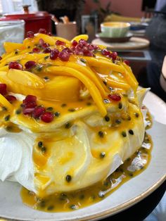 a cake with fruit on it sitting on a plate