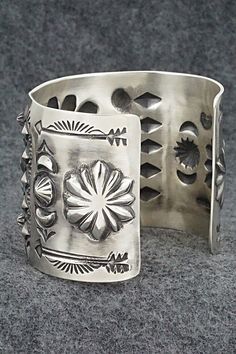 This stunning sterling silver bracelet was made by Navajo silversmith Elvira Bill. The inside is signed Elvira Bill and stamped sterling.Size: 5 7/8" (will fit up to a 7 1/4" wrist)Gap: 1 3/8"Width: 2"Free shipping on all orders! We ship with USPS and always include tracking. All orders ship within a day of payment.Returns are accepted up to 30 days after you receive your order. Just send us a message. Our shop offers cash back or store credit. The item must be returned in new condition. Artisan Sterling Silver Concho Cuff Bracelet, Artisan Silver Concho Cuff Bracelet, Southwestern Silver Bracelets With Concho, Southwestern Silver Bangle Jewelry, Southwestern Silver Bracelet Jewelry, Southwestern Style Silver Bracelet Jewelry, Southwestern Style Silver Bracelet, Southwestern Silver Bracelet, Sterling Silver Bracelet