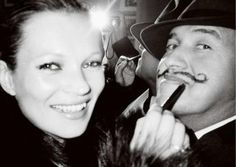 black and white photograph of a woman with a mustache next to a man wearing a top hat