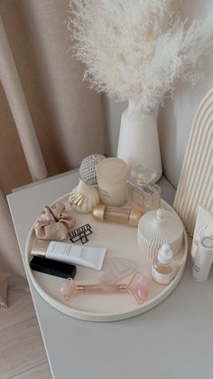 a white table topped with lots of cosmetics and personal care items on top of it