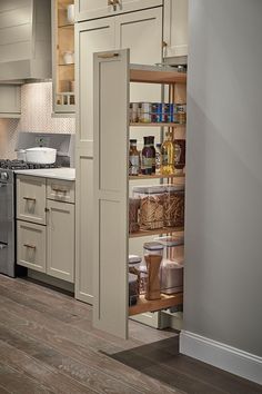 an open cabinet in the middle of a kitchen