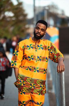 Wear a bit of the sunshine and culture of Africa with out authentic handmade orange Kente shirt, straight from the smiling coast of Gambia. We Are A Brand With A Purpose. Proudly Made In Africa. 100% Smile Guarantee when you hear our ethical story and wear our colourful clothing. Feel Good in our clothing, knowing that we provide a positive social impact on the economy in West Africa. We source and produce everything in West Africa- providing over 30 full time jobs for the local community. See e Orange Relaxed Fit Cotton Shirt, Traditional Orange Cotton Tops, Orange Bohemian Relaxed Fit Top, Orange Bohemian Cotton Top, Yellow Long Sleeve Vacation Shirt, Vibrant Yellow Short Sleeve Tops, Orange Cotton Festival Top, Vibrant Relaxed Fit Cotton Tops, Orange Long Sleeve Shirt For Beach