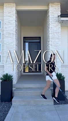 a woman is walking down the steps in front of a house with an amazon top seller sign