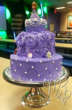 a purple cake sitting on top of a table