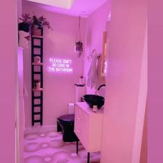 a bathroom with pink walls and flooring has a ladder in the corner that reads please don't do come in the bathroom