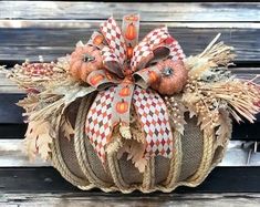 a decorative pumpkin sitting on top of a wooden bench