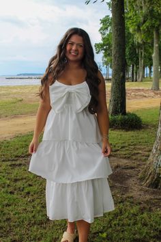 This midi dress boasts a smocked back, adjustable straps, and an adorable bow accent at the front. Both trendy and beautiful, it makes for the ideal little white dress. Little White Dress, Summer Savings, Comfortable Tops, Little White Dresses, Bottom Clothes, Dress Romper, Shoe Collection, Adjustable Straps, White Dress