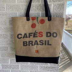 Show your love for coffee!  This large lightweight tote is perfect for a trip to the farmer's market, beach, or to carry your knitting project.  Perfect upgrade to a reusable plastic shopping bag! The tote is made of a real coffee bag from my favorite roaster and is a synthetic burlap, so it is stiffer than real burlap.  I ironed a woven cotton interfacing to the burlap to make it stronger and easier to sew.  The bottom 2.25" of the bag is black 18 oz. cotton canvas, which gives the bag strength to stand up.  The bag was cut to display as much of the bag as possible.   The interior of the bag is cotton canvas in a coffee design in tan/black/beige, with one slip pocket with black accent and antique brass rivets.  The top of the lining is the black canvas. The black leather handles are 1" wi Casual Reusable Tote Beach Bag, Casual Reusable Beach Bag, Casual Reusable Beach Bag For Everyday Use, Eco-friendly Black Tote Beach Bag, Casual Coffee-colored Bag For Everyday Use, Casual Coffee-colored Everyday Bag, Casual Reusable Beach Bag For Shopping, Casual Everyday Reusable Beach Bag, Casual Recyclable Beach Bag