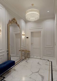 a white room with a blue bench and large mirror on the wall next to it