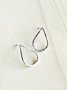 Gorgeous, handcrafted, hammered teardrop stud earrings in Sterling Silver. Dainty, minimalist and perfect for everyday wear! Teardrops measure 1/2" and are set atop Sterling Silver stud posts and include matching ear nuts. 100% hypoallergenic, waterproof and tarnish resistant. Handmade in the USA. All of our jewelry items arrive wrapped, perfect for gift giving! Silk Bag, Detail Shop, Hammered Silver, Sterling Silver Studs, Silver Earrings Studs, Silver Studs, Nuts, Metallic Silver, Silver Earrings