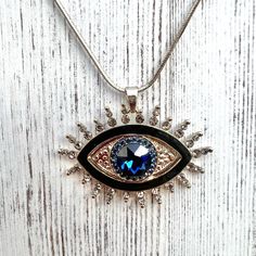 Protection evil eye pendant necklace evil eye charm for protection jewelry for protection and good energy necklace long necklace evil eye  Fashionable necklace showcasing an evil eye pendant. The silver tone snake chain is made of zinc alloy which has good corrosion resistance, and the evil eye pendant features a big blue zircon surrounded by small inlay zircons.  Interest facts: *Wearing any piece of jewelry with the evil eye symbol on it provides the wearer with both power and protection again Silver Metal Evil Eye Jewelry, Silver Metal Jewelry With Evil Eye, Spiritual Metal Evil Eye Necklace, Spiritual Evil Eye Metal Necklace, Silver Charm Necklace With Evil Eye Pendant, Silver Evil Eye Charm Necklace With Round Pendant, Silver Evil Eye Pendant Necklace, Energy Necklace, Necklace Evil Eye