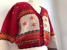 "Bright red and orange vintage le chateau cropped sweater. Amazing stitched snowflake/star details and ornate buttons. Interior tag reads \"100 % cotton, size medium. Hand wash cool water, lay flat to dry.\" Measurements: bust (armpit to armpit)- 22\" length- 20\"  sleeve (armpit to cuff)- 18\" Thanks for checking out wild mint vintage~" Handmade Red Outerwear For Fall, Bohemian Winter Sweater With Buttons, Winter Long Sleeve Cropped Sweater With Buttons, Red Knitted Outerwear For Fall, Red Buttoned Sweater For Winter, Red Sweater With Buttons For Winter, Cropped Winter Sweater With Buttons, Red Knitted Sweater For Fall, Cropped Buttoned Winter Sweater