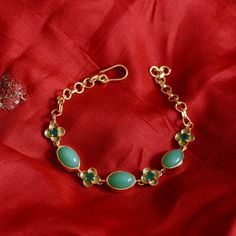 This beautiful bracelet has been handmade in our workshops. We have interwoven chrysoprase with green onyx. The bracelet is made in sterling silver coated with 24ct gold vermeil and is adjustable so will fit anyone.  Central motif dimensions are 9mm x 11mm. Handmade in Jaipur, India  Sterling silver coated with 24ct gold vermeil embedded with chrysoprase and green onyx.  Store your jewellery in a soft lined pouch or box separately so they don't damage each other.  Precious metals naturally tarni Handmade Elegant Aventurine Bracelets, Elegant Aventurine Bracelet Jewelry, Elegant Aventurine Bracelet, Green Handmade Bracelets For Formal Occasions, Green Handmade Bracelets For Formal Events, Green Hallmarked Bracelet For Gift, Formal Gold Chrysoprase Jewelry, Green Hallmarked Bracelet Gift, Green Onyx Bracelet Jewelry Gift