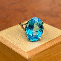 Estate/ vintage 10KT yellow gold oval-cut, genuine, blue topaz ring. Stunning blue color! Blue Topaz is the birthstone for December babies- and this piece makes a spectacular gift! Size 7.5 Can be resized for an additional fee Weight: 5.8 grams Topaz measures: 18mm x 13mm Genuine, oval-cut, checkerboard, faceted blue topaz Stamped 10KT Excellent estate condition Gift Topaz Ring With Center Stone, Oval, Oval Aquamarine Birthstone Ring As Gift, Oval Aquamarine Birthstone Ring For Gift, Oval Blue Birthstone Ring, Anniversary Topaz Ring With Oval Cabochon, Blue Oval Birthstone Ring In Fine Jewelry Style, Oval Topaz Ring With Accent Stones As Gift, Oval Turquoise Sapphire Ring As A Gift, Oval Cabochon Topaz Ring Gift