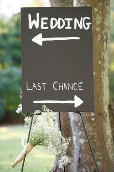 a sign that says, wedding last chance with flowers on it next to a tree