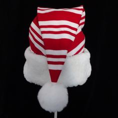 "This novelty Santa hat is made up in a Christmas red and white candy cane striped soft cotton flannel fabric. The hat brim is a snowy white faux Sherpa fur fabric. The sizing on the hat is generous and will fit most adult or teen head sizes. The styling is the classic slouch stocking cone, traditional Santa look. There is a snowy white pompom stitched on the top. Opening measurement is 24-25\" circumference, tapering in cone style and the length of the hat is 19\". Please check the measurements Christmas Red And White, Santa Claus Costume, Candy Cane Ornament, White Flannel, Candy Cane Stripes, Fur Fabric, White Candy, Fur Fabrics, Costume Hats