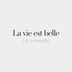 the words la vie est belle are in black and white