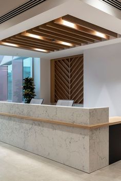 an office lobby with a marble reception desk