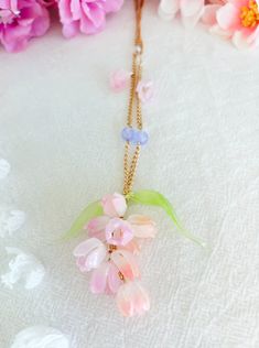 Elevate your style with our exquisite Handmade Shrink Plastic Crocus Necklace, a wearable work of art capturing the essence of delicate blooms. Crafted with meticulous attention to detail, each pendant showcases the vibrant hues of crocus petals, making it a perfect accessory for nature enthusiasts and flower lovers alike. The lightweight and durable shrink plastic material ensure comfortable wear, while the intricate design adds a touch of whimsy to any outfit. This unique floral necklace is a testament to craftsmanship and creativity, making it an ideal gift for those who appreciate handmade, nature-inspired jewelry. Embrace the beauty of spring all year round with this stunning crocus necklace - a truly distinctive piece for your jewelry collection! Delicate Spring Jewelry With 3d Flowers, Spring Blossom Jewelry With Flower Decoration, Spring Blossom-colored Flower Decorated Jewelry, Whimsical Flower Jewelry For Spring, Whimsical Flower-shaped Spring Jewelry, Delicate Spring Jewelry With Flower Decoration, Elegant Flower Necklace Spring Gift, Elegant Flower Necklace For Spring, Elegant Spring Flower Necklace As A Gift