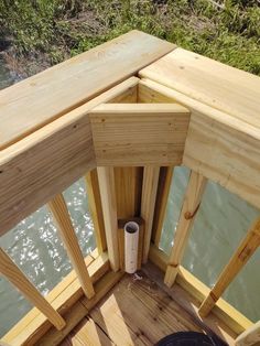 the inside of a wooden dock with water in the background