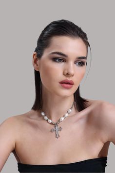 💎 Elevate your look with our Zircon and Pearl Cross Necklace, a stunning piece that combines sparkling zircon stones with the timeless beauty of pearls. This show-stopping pendant is perfect for those who love bold, elegant jewelry that makes a statement. Whether you're dressing up for a special event or adding a touch of glamour to your daily look, this cross necklace is sure to shine! ✨ At LuxoticaBoutique, we bring together cool, modern designs with classic sophistication. Each piece is craf Crystal Pearl Necklace With Clavicle Chain, Elegant Silver Cross Pearl Necklace, Elegant Pearl Necklace With Cross Pendant, White Pearl Necklace With Metal Pendant, White Pearl Pendant Jewelry, White Pearl Pendant Necklace In Metal, Elegant Cross Pendant Necklace With Pearl Drop, Elegant Pearl Drop Cross Pendant Necklace, Silver Crystal Jewelry With Pearl Pendant