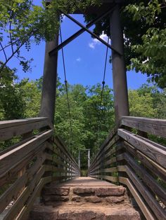 a wooden bridge with steps leading to the top