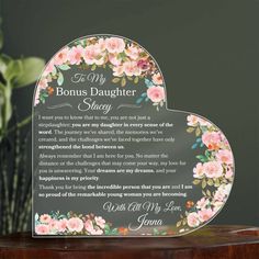 a heart shaped plaque with flowers on it that says,'i love my daughter '