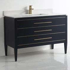 a bathroom vanity with a white sink and black drawers on the side, against a white wall