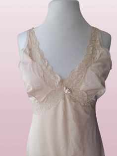 Vintage 70s lingerie, nylon nightgown , new oldstok , beige under dress , retro lace , slip dress S-M ,newer worn Bust: 92 cm / 36 in Waist: 80 cm/ 31 in Hips: 110 cm/ 43 in Lenght:  100 cm/ 39 in Size : S-M Materials: 100% nylon Condition: perfect vintage condition Defects: none See more like this in my shop: https://www.etsy.com/shop/VintageInsparation?ref=seller-platform-mcnav Lace Slip Dress With Built-in Bra For Daywear, Feminine Sleeveless Slip Dress With Lace Bodice, Feminine Camisole Slip Dress With Delicate Lace, Feminine Sleeveless Lace Slip Dress, Feminine Lace Sleeveless Slip Dress, Fitted Cami Slip Dress With Delicate Lace, Sleeveless Lace Slip Dress With Built-in Bra, Lace Slip Dress With Built-in Bra, Fitted Beige Lace Top Camisole