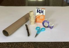 craft supplies are laid out on a table with paper, scissors, and glue to make it look like they were made from toilet paper towels