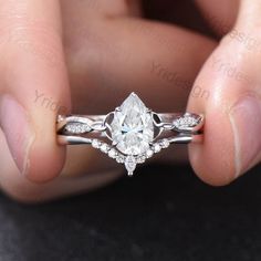 a person holding an engagement ring in their hand with the diamond on it's side