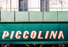 there is a sign that says piccolina on the side of a storefront