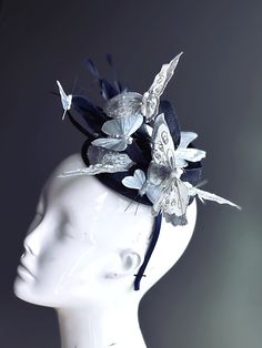 Transform your look with our stunning Fascinator Hat, adorned with silver butterflies. This whimsical headpiece is perfect for adding a touch of magic and sophistication to any special event! Age Group/Gender - Adult/Women Size/Type - One size fits all adults Color - Silver Special Features - Butterflies Elegant Fascinator For Royal Ascot Costume Party, Elegant Fascinator For Costume Party At Royal Ascot, Elegant Headband For Masquerade, Silver Fitted Fascinator For Evening, Elegant Headpieces For Kentucky Derby Costume Party, Elegant Headband Fascinator For Costume Party, Adjustable Silver Headpiece For Carnival, Silver Adjustable Headpieces For Carnival, Silver Evening Hat Headpiece