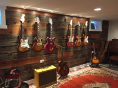 guitars and amps are lined up on the wall