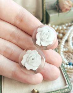 "Beautiful French Antique circa 1920s Reverse Carved Lucite Round Floral Vintage Clip On Earrings, Gift for Woman Size -   in diameter - approx. 21,5mm /  0,85\" Earrings are in a great vintage condition, smooth and shiny, with beautiful reverse carved white flowers on a clear background. Lovely, delicate and eye catching.  Rare and unique piece! ✨  Earrings will be perfect as a gift for a vintage loving woman! 🧡 Great also for a vintage wedding jewelry 🌼 Found somewhere in France :)  __ Maybe you are looking for something specific from France? 🕵️♀️😗 If you like, you can contact me and ask! With a pleasure I will look for it and check if I can find it for you! ❤️" Classic White Round Flower Earrings, Handmade Vintage Clip-on Earrings For Wedding, Vintage Handmade Clip-on Earrings For Wedding, White Victorian Round Earrings, Victorian White Round Earrings, Victorian Style White Round Earrings, Vintage Round Clip-on Earrings As Gift, Vintage Flower Earrings For Wedding, Vintage Round Clip-on Earrings For Gift